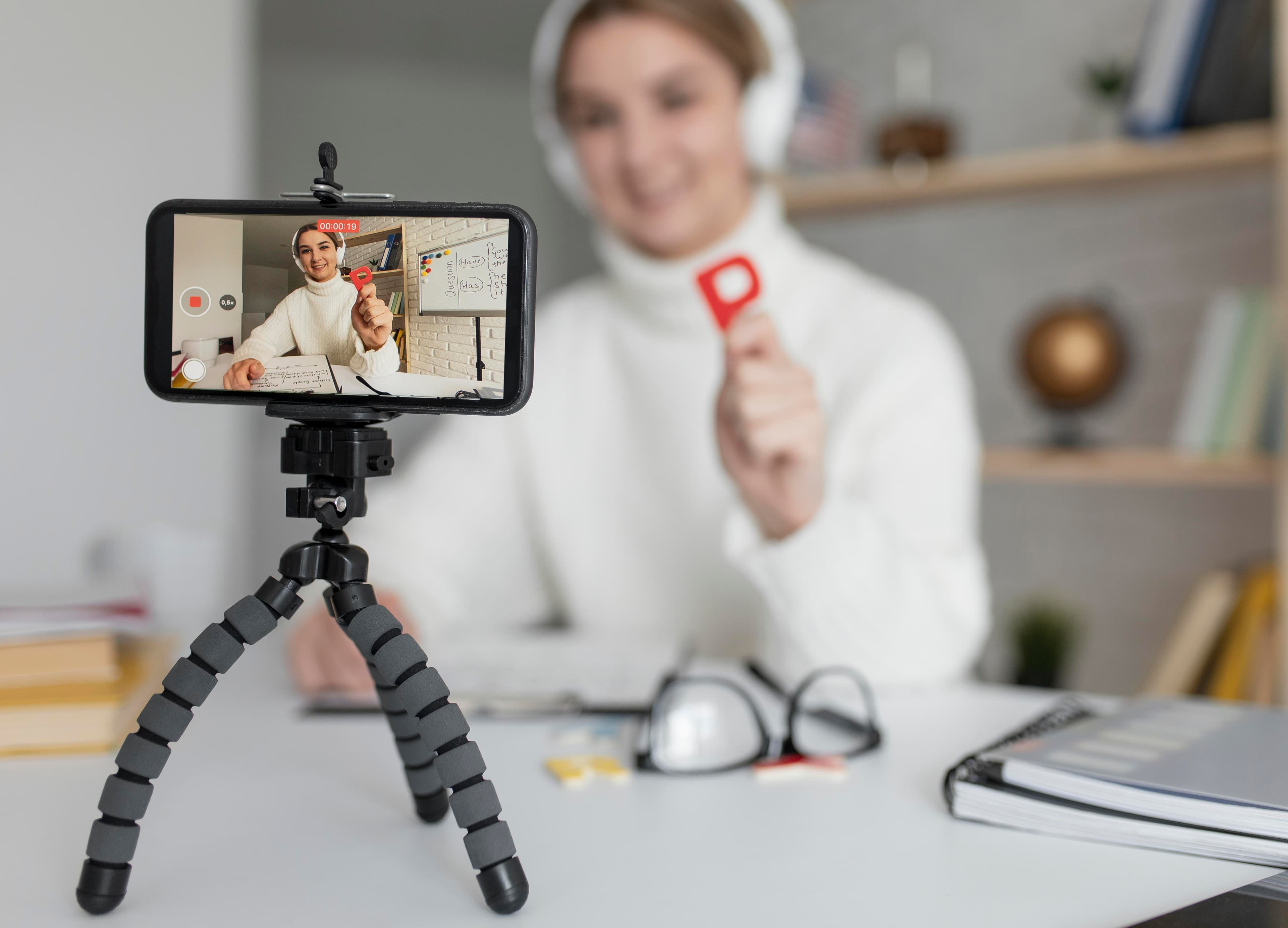 YouTube creator filming a video with a smartphone before production